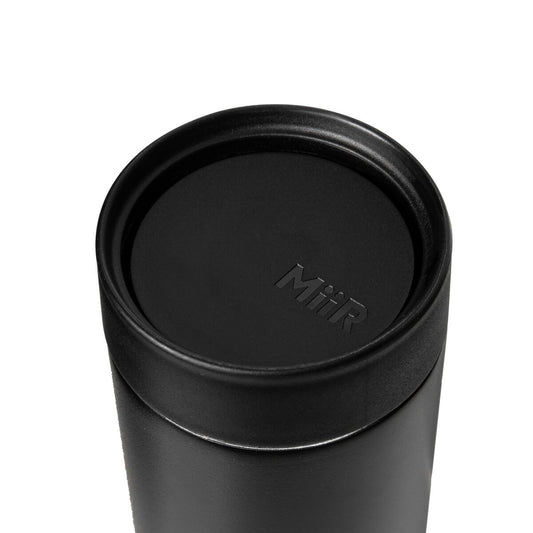 Black tumbler with a lid on a white background