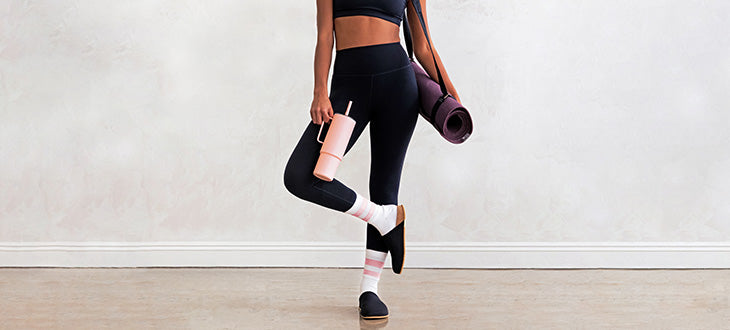 Woman holding a MiiR All Day Straw Cup in an exercise room
