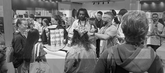 People surrounding MiiR coffee stand at World of Coffee 2026