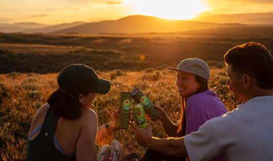 Happy people watching sunset over mountains and cheers MiiR Wide Mouth & Bale Breaker beer together