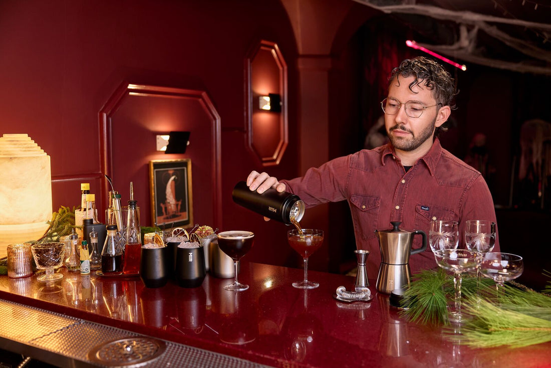 Person making cocktails with MiiR Shaker and Barware Sets.