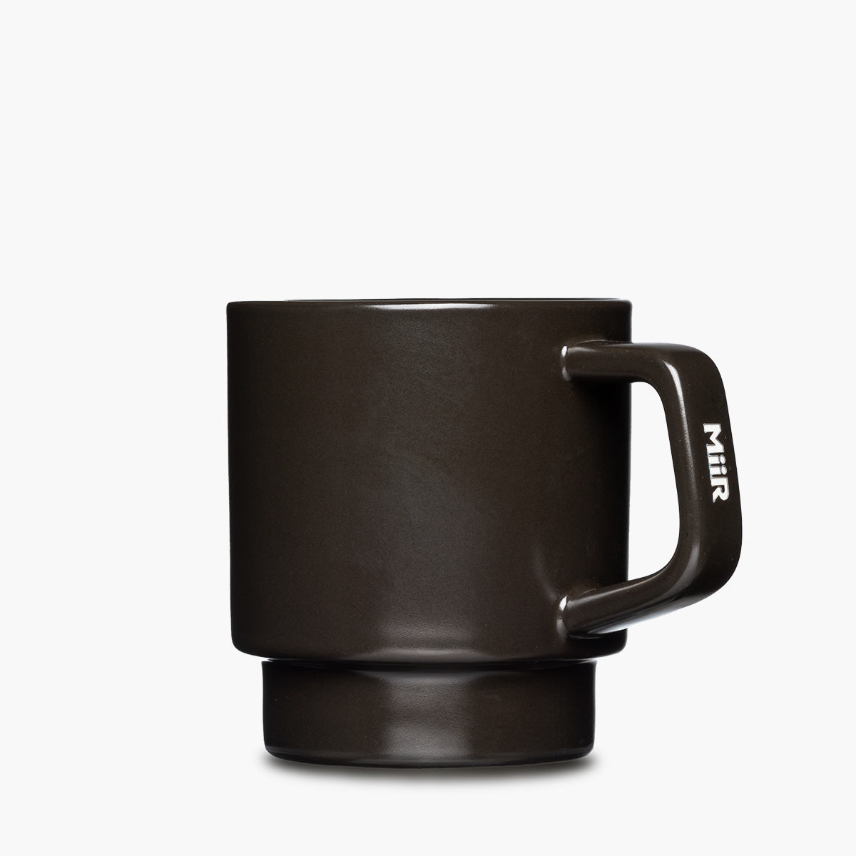 A matte black ceramic mug with a matching handle and base, featuring the brand name 'MiiR' etched vertically in white on the handle.
