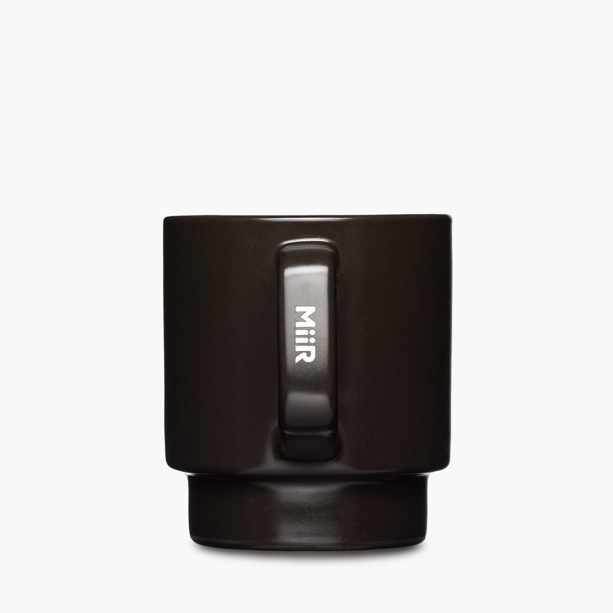 A matte black ceramic mug with a matching dark brown base, featuring a vertical handle with the brand name 'MiiR' etched in white.