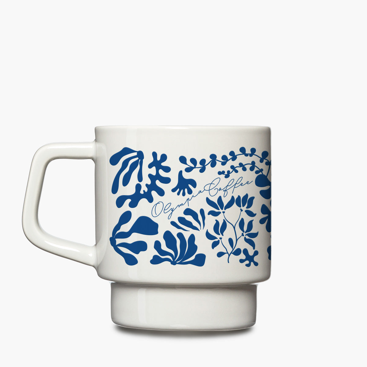 A white ceramic coffee mug with a blue botanical pattern and the text 'Olympic Coffee' and Kelp design printed on the side, set against a plain light gray background.