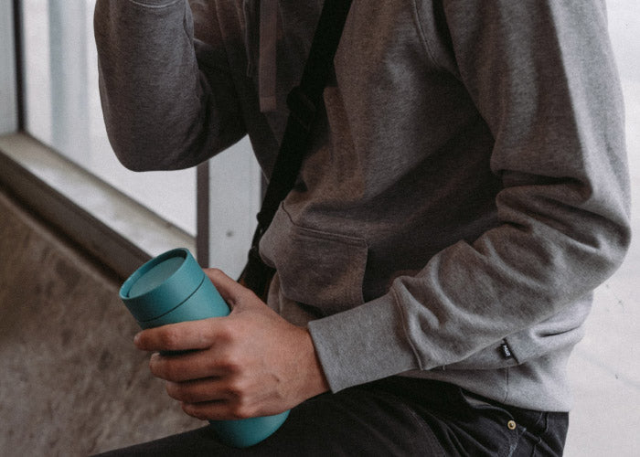 Person wearing a grey MiiR sweatshirt