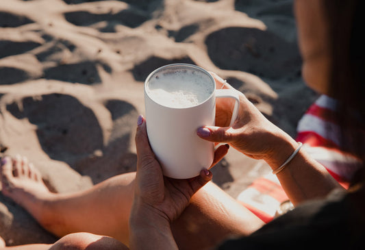 Person using the MiiR Camp Cup at a beach
