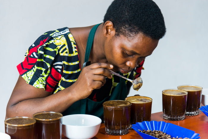 IWCA Rwanda person coffee cupping