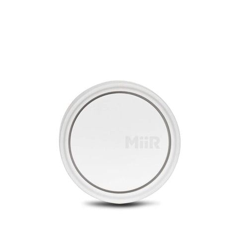 White wireless charging pad on a white background